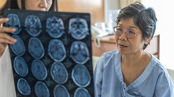 Doctor reviewing brain scan with patient